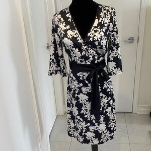 Floral black and cream wrapped dress in silky polyester and spandex blend size 9